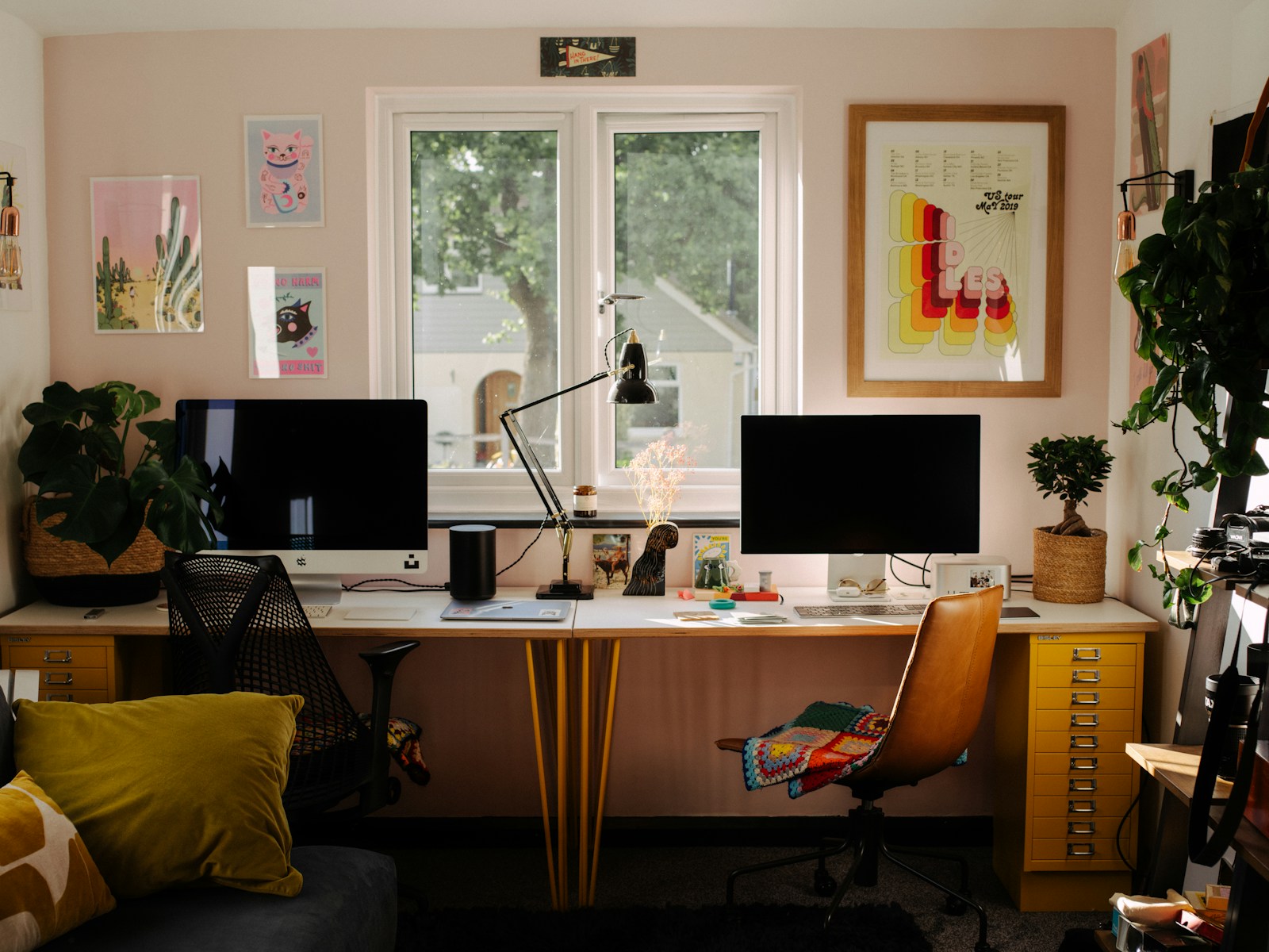 A desk with two monitors in a focused creative workspace.